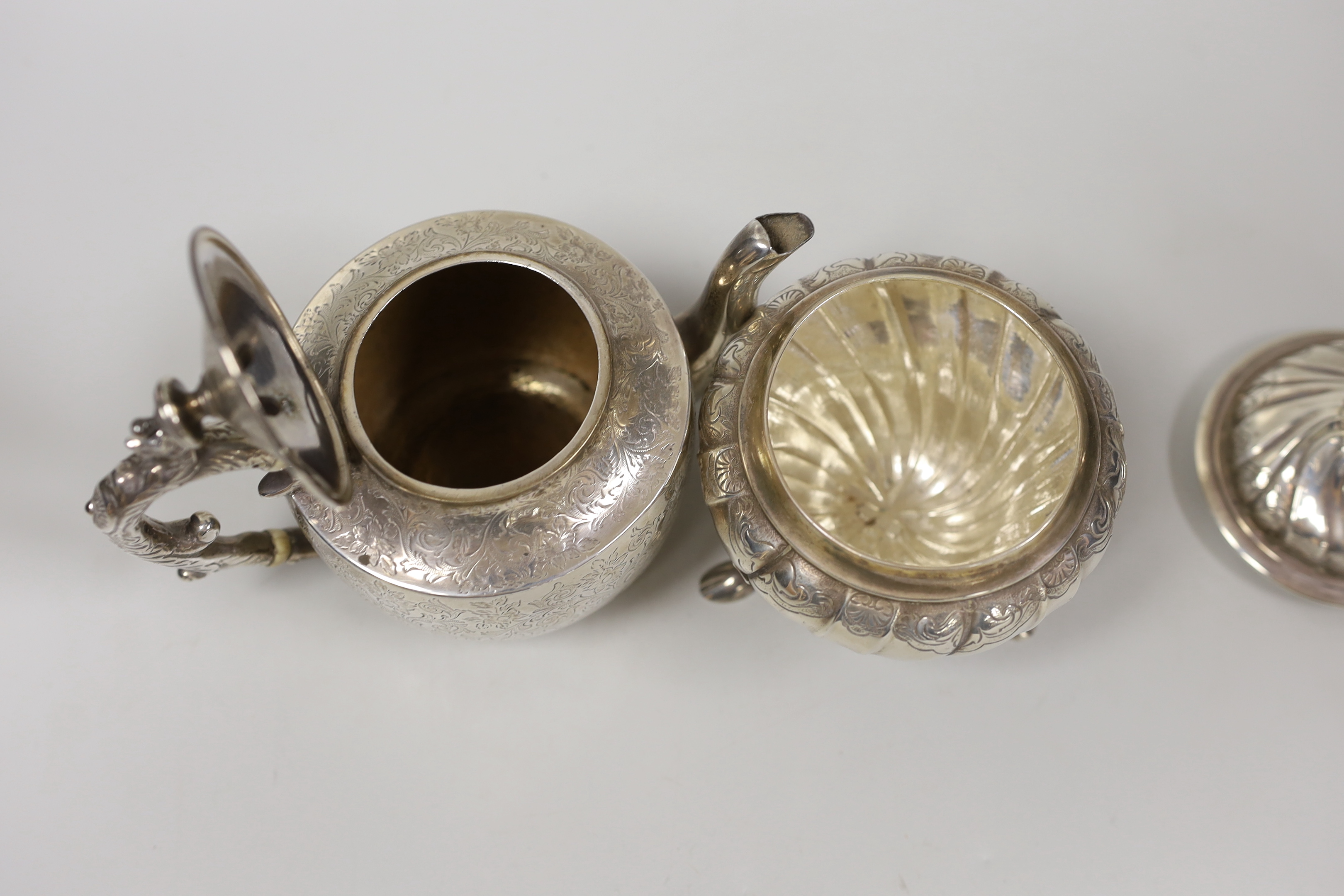 A small Victorian Scottish silver bachelor's teapot with ivory insulators, Glasgow, 1888 together with a small 1930's lidded silver tea caddy, gross weight 19oz.